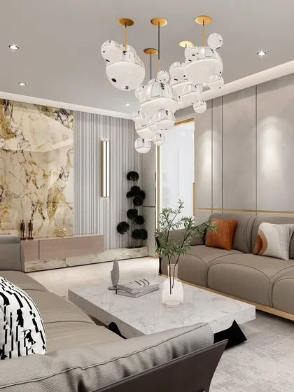 A view highlighting the feature marble wall, which adds a touch of luxury and texture. The neutral furniture allows the opulent details, like the chandelier and marble, to stand out.