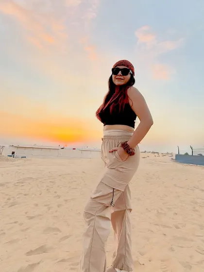 Posing against the beautiful sunset in the Dubai desert. I paired a simple black crop top with comfortable beige cargo pants for the safari adventure.