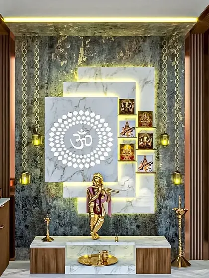 This elegant pooja unit uses a combination of marble, wood, and backlit panels to create a serene space. The hanging lamps and intricate Om carving add a traditional touch to the modern design.