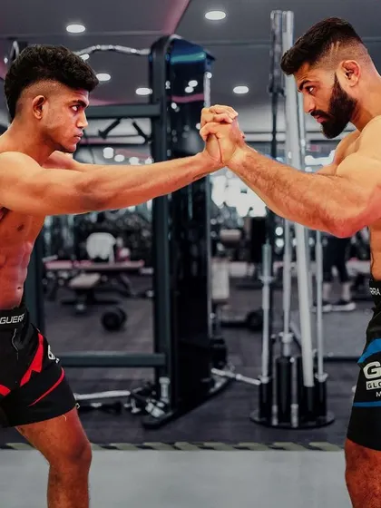 The intensity of a fighter's focus. Two of our athletes locked in a test of strength, showcasing the power and physique built at our gym.