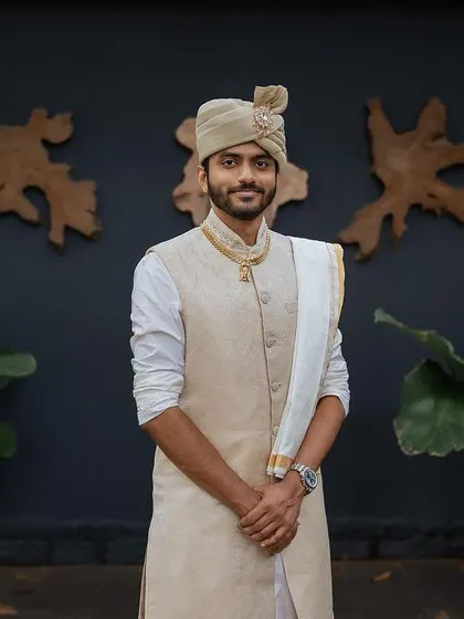 A stylish portrait of the groom in his traditional attire, showcasing his calm and confident presence before the ceremony.