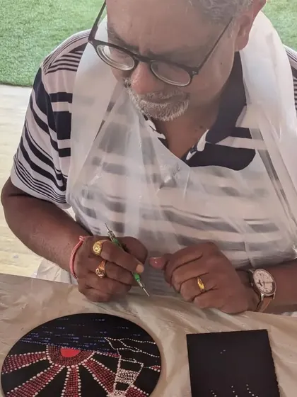 An older participant enjoying the process of creating a dot mandala. Art is for everyone, at any age.
