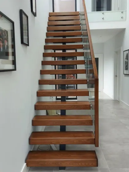The slender profile of the centre-spine staircase allows light to pass through, making the hallway feel larger and more welcoming.