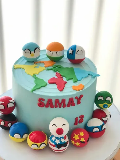 A cake for a geography whiz, featuring a world map and handcrafted "country balls" representing different nations.