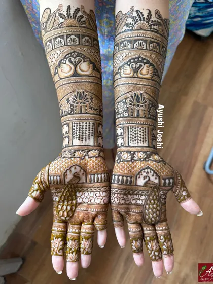 A stunning full-length engagement mehendi featuring majestic peacocks, graceful swans, and rows of tiny elephants, creating a truly royal look.