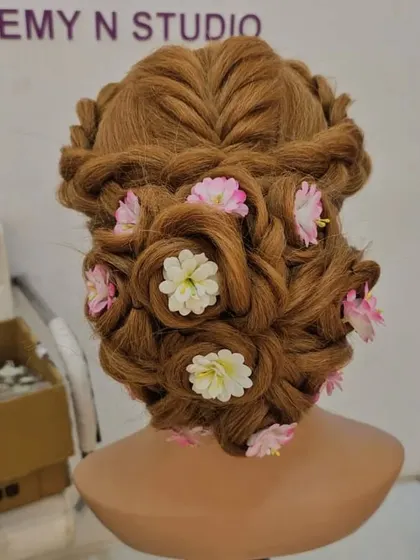Hairstyling is a key skill for any professional artist. Here is an intricate floral updo created on a mannequin during a practice session. My course covers everything from basic braids to complex international bridal updos.