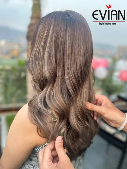 A closer look at the hand-painted details in this balayage. Each strand is carefully colored to contribute to the overall blended and natural look.