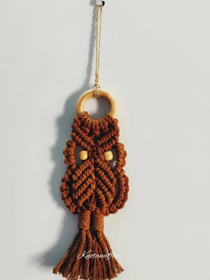 Another shot of the pretty brown macrame owl. It's customizable and perfect for adding a touch of whimsy to your decor.