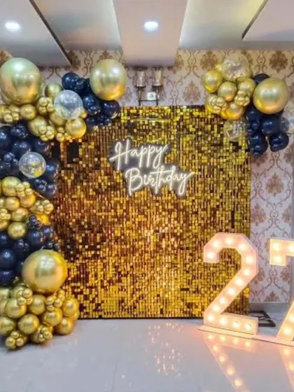 This video shows our team setting up a gold sequin wall with a black and gold balloon ring, giving you a glimpse of how we transform a stage into a glamorous party zone.