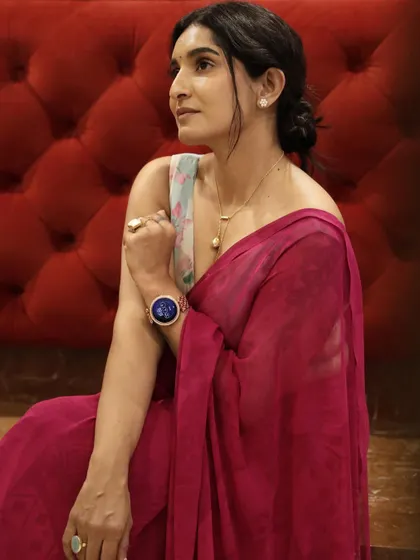 The deep pink saree drapes beautifully, creating a soft and romantic look.