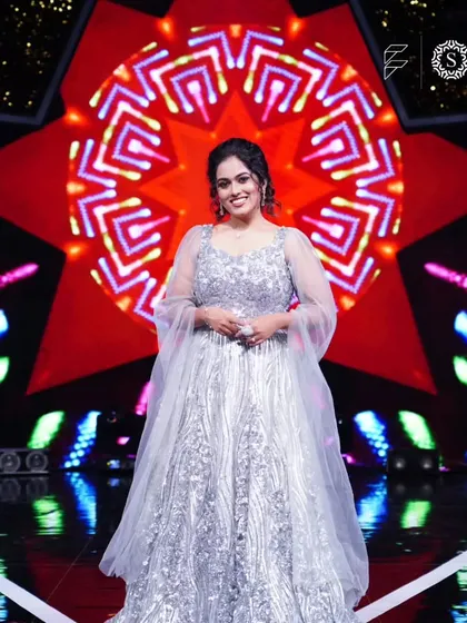 A full-length shot of Sayli Kamble looking like a star in our silver gown. We are so proud to have her as a happy client.
