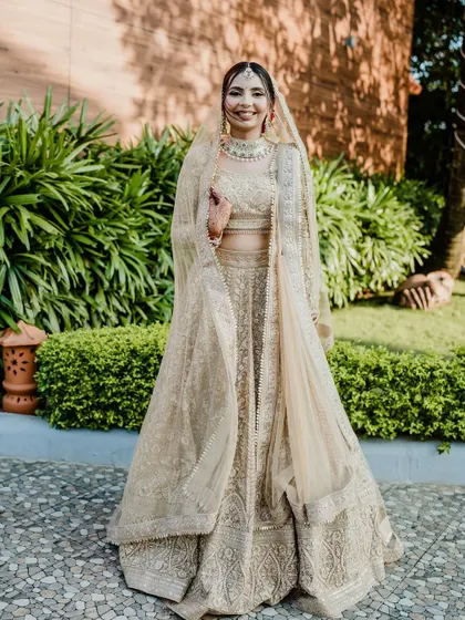 A full-length shot of my unique bride Nirali in her all-golden lehenga. The makeup was designed to be luminous and radiant to create a cohesive, magical look.
