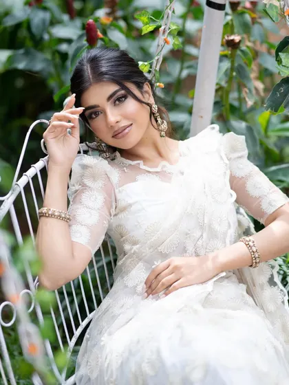 An exquisite white self-embroidered saree with a puffed-sleeve blouse, a minimalist and elegant choice.