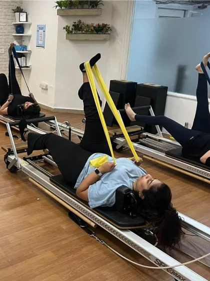 Various shots of members and instructors in action during our dynamic Reformer Pilates classes.