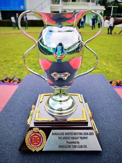 The Ardent Knight Trophy, a magnificent silver cup reflecting the sky and turf.