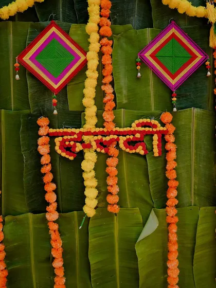 A close-up of the vibrant Haldi decor, featuring marigold garlands and traditional elements against a backdrop of banana leaves. I always capture the details that create the wedding's atmosphere.