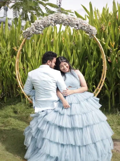 A romantic shot on a floral swing, perfect for a pre-wedding or maternity album.