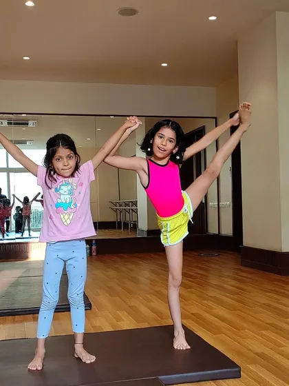 Teamwork makes the dream work! Our young gymnasts love practicing their balance and flexibility poses together.