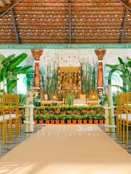 The aisle leading to the ceremony stage, lined with golden chairs. This view shows how we create a cohesive and grand experience for guests from the moment they enter.