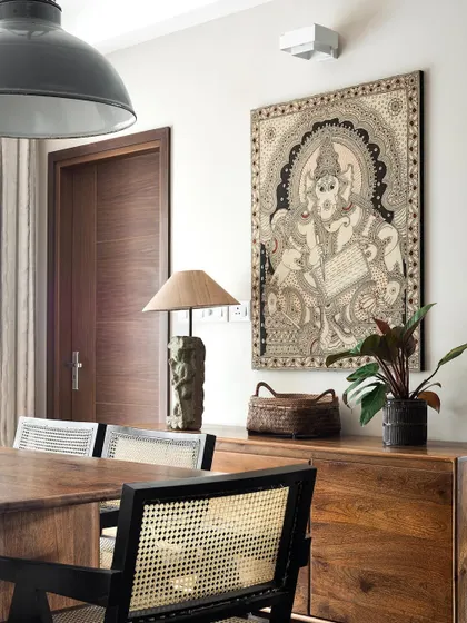 Traditional Indian Kalamkari art is featured prominently in the 'Ikigai Living' dining area. We believe in creating a backdrop that allows our clients' treasured art and collectibles to take center stage.