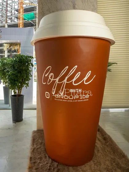 Another view of the giant coffee cup prop, showcasing its scale and impact. Custom props like this are a key part of how we create truly unique and memorable events.