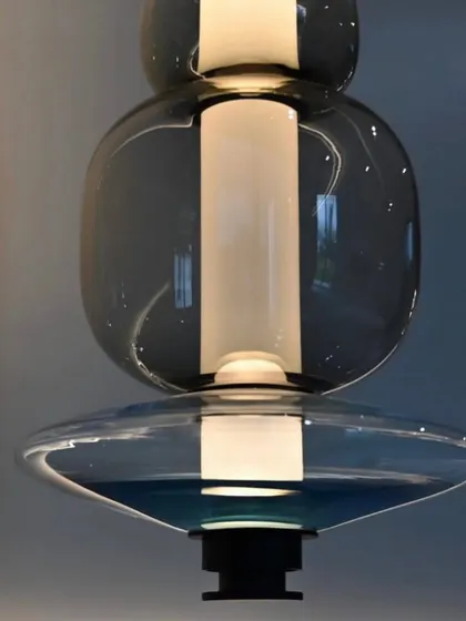 This image details the deep blue and clear glass combination of a Luna pendant, showcasing the vibrant color options available.