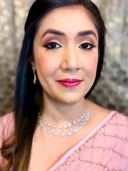 The final look for the sister of the bride. The makeup is soft, enhancing her features and giving her a healthy glow.