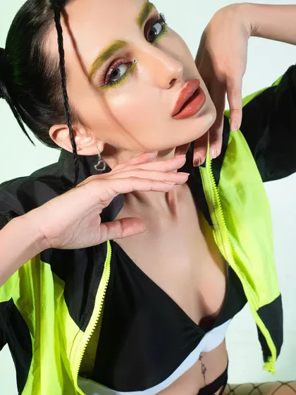Embracing electric energy with this sporty, high-fashion look. I styled a neon and black windbreaker with fishnet stockings and bold makeup to create a vibrant and edgy aesthetic.
