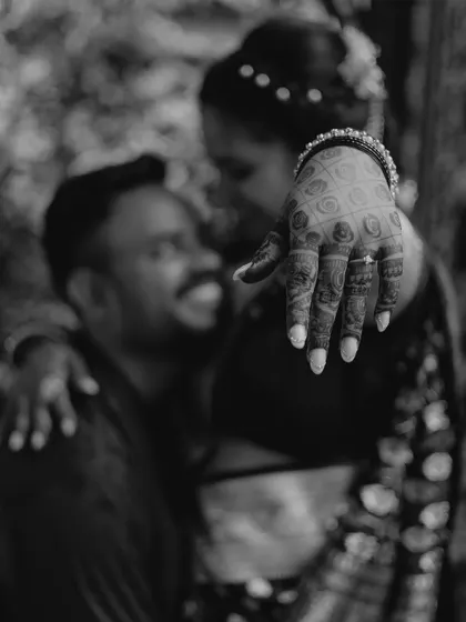 An artistic, shallow-depth-of-field shot focusing on the bride's hand and engagement ring. This black and white photo is both romantic and creative.