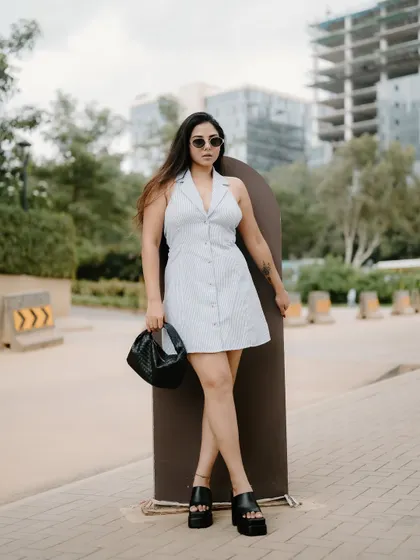 A duplicate of image 36, this full-length fashion portrait with the Bangalore cityscape in the background is stylish and contemporary.
