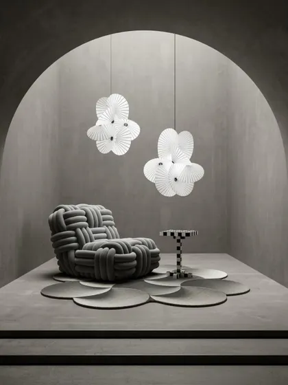 A pair of large Serpentine Lights in a minimalist, arched space. Their perpetual, twisting movement makes them an elegant suspension light that keeps you guessing.
