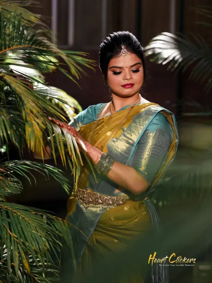 A lovely portrait of the bride surrounded by palm leaves, adding a touch of tropical elegance to her engagement photos.