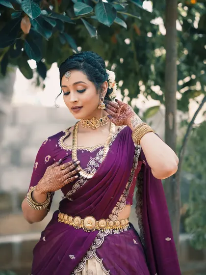 An elegant portrait of the client, with her mehendi-adorned hands gracefully posed.