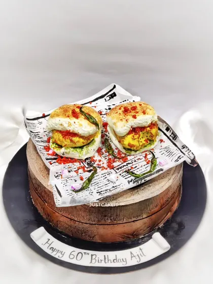 I love a creative challenge, like this hyper-realistic Vada Pav cake made for a 60th birthday. Everything you see, from the pav to the chillies, is completely edible and sits on top of a delicious butterscotch cake.