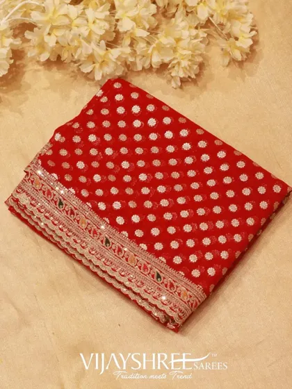 A folded view of the red Georgette saree, showcasing its rich color and intricate border.