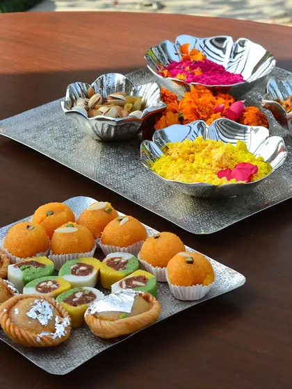 This Holi, serve your sweets and snacks on our elegant chatai-textured silver trays and matching floral bowls. It's a stylish way to present your festive treats.