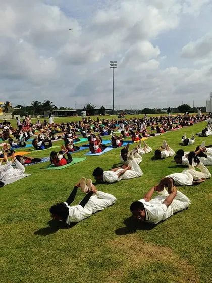 Students perform the Dhanurasana (bow pose) during a morning yoga session, enhancing their core strength and spinal flexibility.