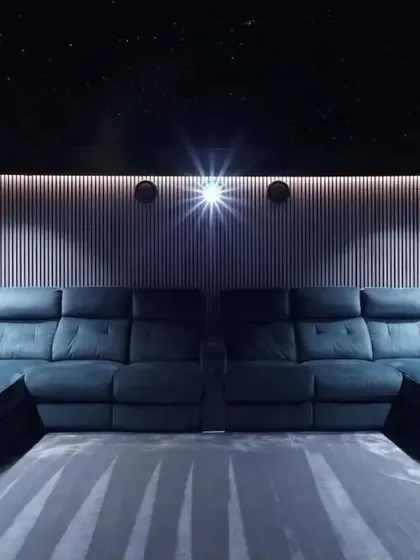 This front-on view showcases the symmetrical design of the room, with identical chaise lounges flanking the center. The vertical wall panels add texture and acoustic benefits.