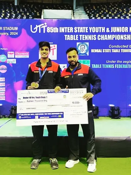A close-up shot with Aakash K J and his national medal, capturing the coach-player bond that is crucial for success at this level.