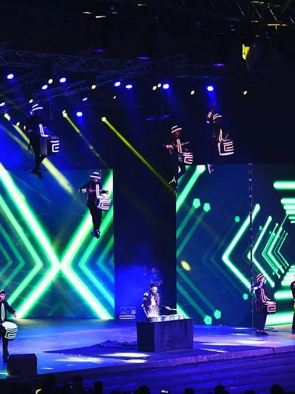 This is my signature Aerial Drumming Troupe in full flight for an Infosys awards ceremony in Bangalore. We rig performers high above the stage, combining synchronized drumming with a massive LED light show for an unforgettable opening act.