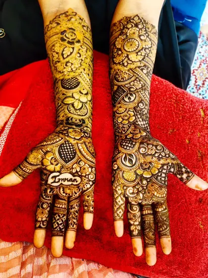 A personalized design with the name "Imran" written on the palm, surrounded by intricate patterns.
