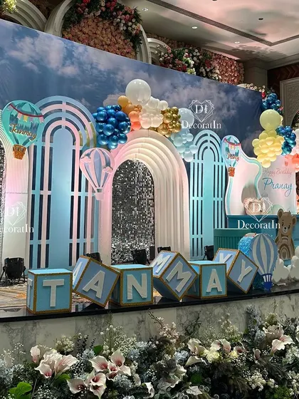 We created a dreamy sky for this joint birthday celebration, featuring a stunning backdrop with hot air balloons, fluffy clouds, and shimmering silver panels. The custom name blocks for Tanmay and Pranay add a perfectly personalized touch.