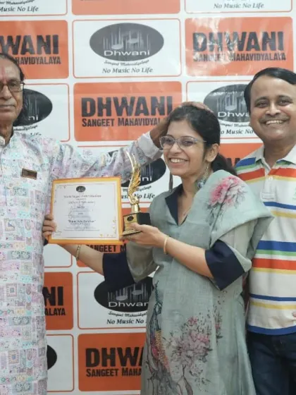 An adult student and her family celebrate her award with her guru.
