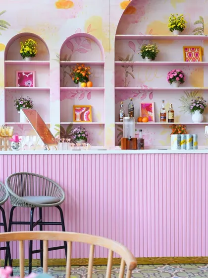 The pink-fluted bar and hand-painted watercolor backdrop we created for the indoor Haldi celebration.