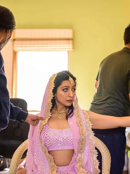 A candid moment during the final stages of hair and makeup.