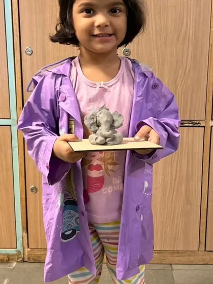 Even our littlest artists can create something amazing. This young participant is all smiles with her small, adorable Ganpati idol.