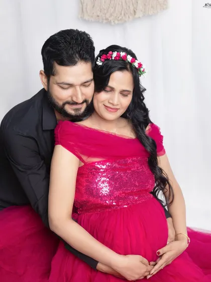 A quiet moment of togetherness. The husband’s gentle embrace around his wife and their baby bump shows the protective and loving 'rishta' you share. Capturing this connection is the heart of my couple sessions.