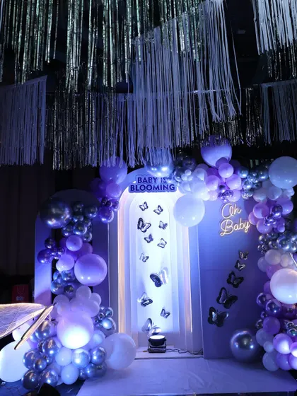 A beautiful butterfly-themed baby shower in shades of purple and silver. The shimmering streamers from the ceiling added a touch of glamour.