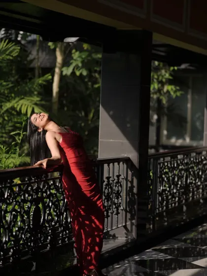 An artistic shot with beautiful shadows, highlighting the silhouette of the red gown.