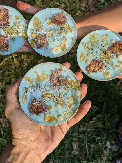 A collection of personalized coasters made from preserved wedding flowers, ready to be gifted. Each one is a small piece of a big day.
